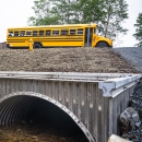 school bus passing over a fish passage culvert