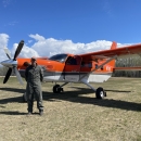 person stands in front of an airplane
