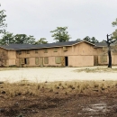 Combat town at Camp Lejeune with a pine tree that is home to a red-cockaded woodpecker cluster. 