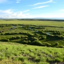 Distant view of a river winding through prairie.