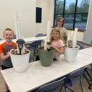 Three people smiling with their DIY frog hotels
