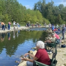 Elderly people fishing at stream