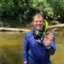 Headshot of Josh Hundley holding a mussel