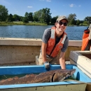 Fish and wildlife biologist Alex Vidal with a sturgeon