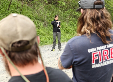 Biologist standing in front of a group, addressing them.