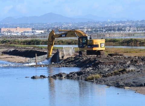 Backhoe in dredge opening