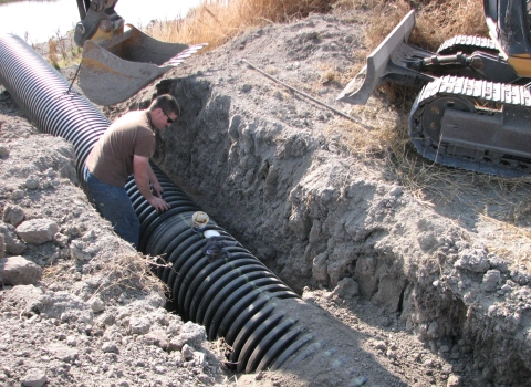 FWS Staff Installing Drain Pipe at Tule Lake NWR
