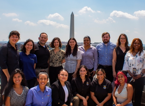 A group of people in formal attire standing in front of the Washington Monument in Washington D.C.