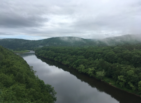 A view of a rolling hills and a river