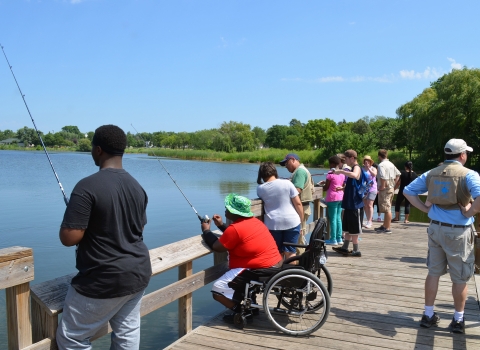 A diverse of anglers on a fishing pier.