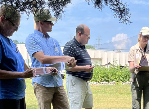 Workshop participants standing in a semi-circle outdoors