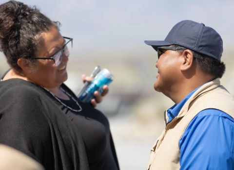 Two people smile at each other