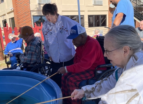 Elderly people fishing in tank
