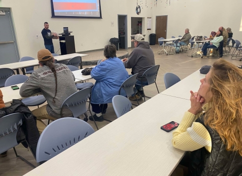 People listening to presenter in classroom