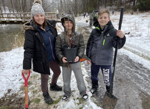 Family poses for tree planting at Cherry Valley National Wildlife Refuge