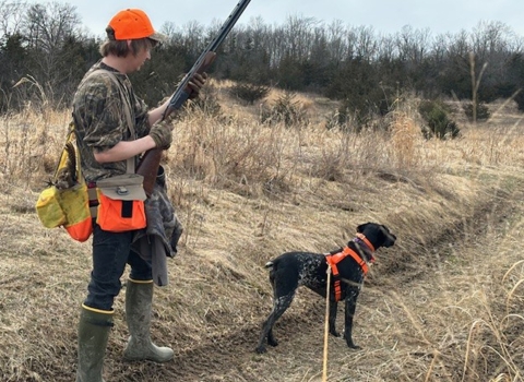 Hunter and dog during a pheasant hunt in Vermont 
