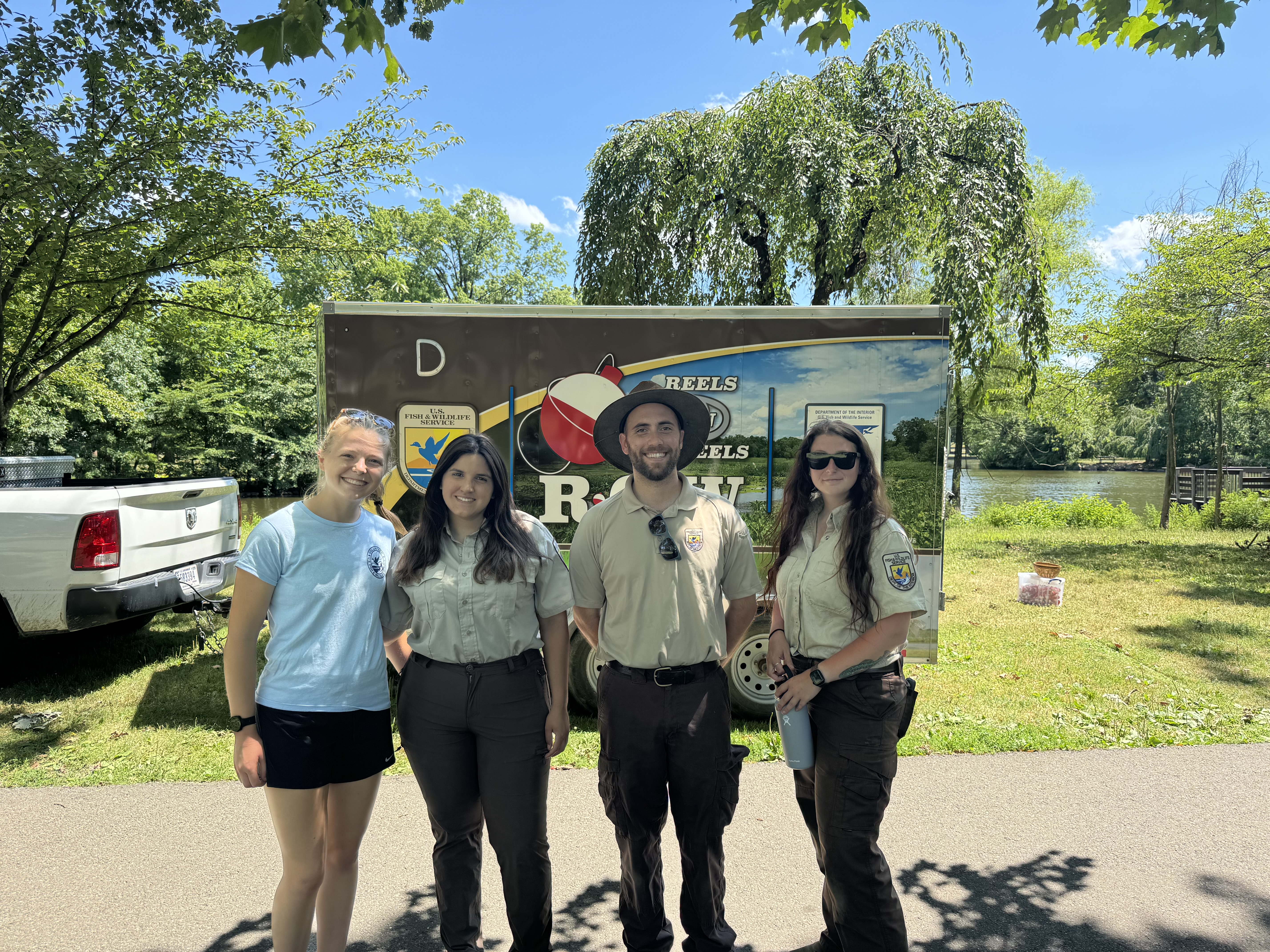 U.S. Fish and Wildlife Service staff pose in front of the Reels on ...
