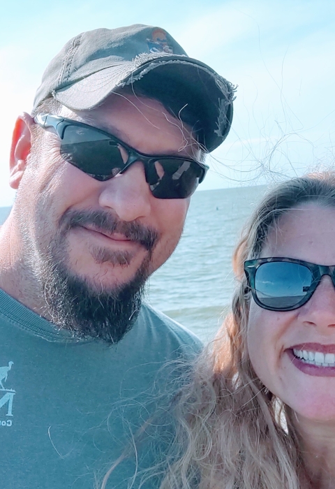 Ronald & Carrie taking selfie with ocean behind them.