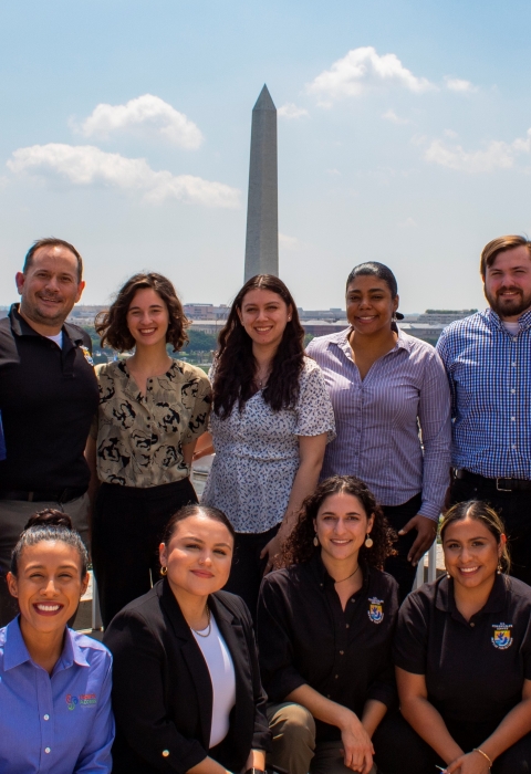 A group of people in formal attire standing in front of the Washington Monument in Washington D.C.