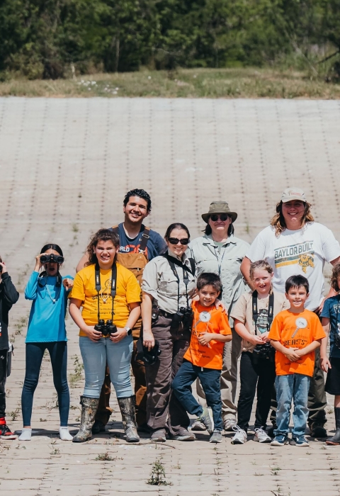 group of children holding binoculars