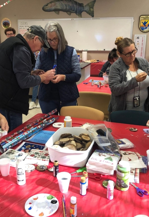 People gathered around a table making crafts