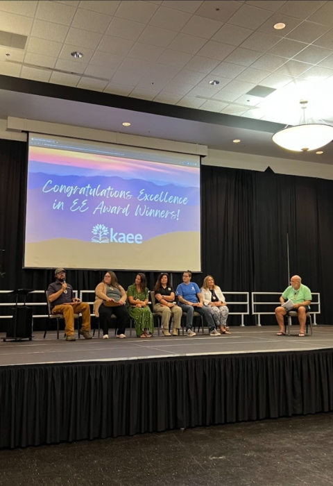 People seated on stage for a interview panel