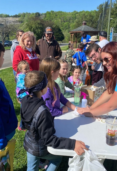 Kids gathered around table getting temporary tattoos