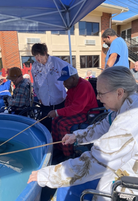 Elderly people fishing in tank