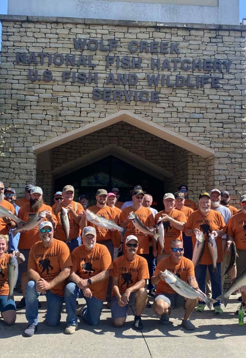 Group of people holding fish