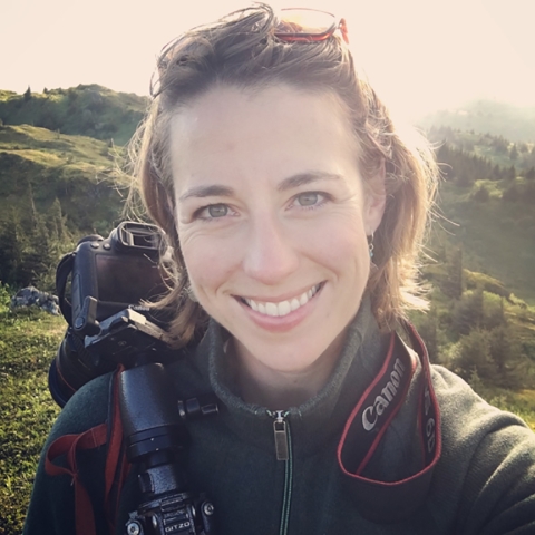 woman with a camera on her shoulder