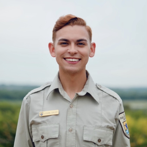 Photo of Logan Sauer with wetland in the background