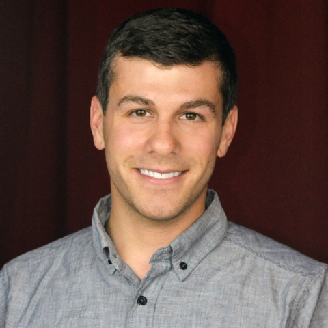 Joe Szuszwalak smiles in a portrait headshot