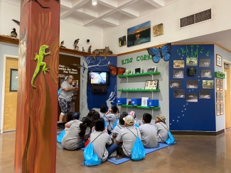 Kids looking at a video on the "Kids Corner" at Santa Ana National Wildlife Refuge. 