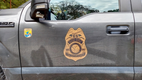 A photo of the USFWS law enforcement emblem on a truck door.