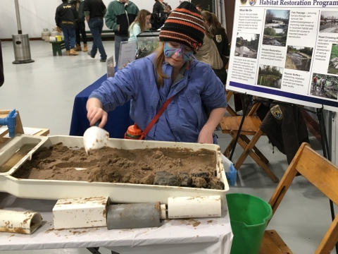 Child interacting with stream table display.
