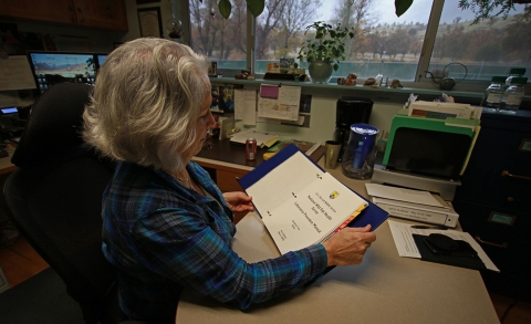 a woman holding a manual