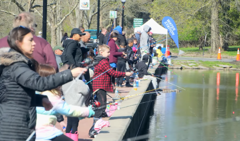 A group of people fishing from a dock