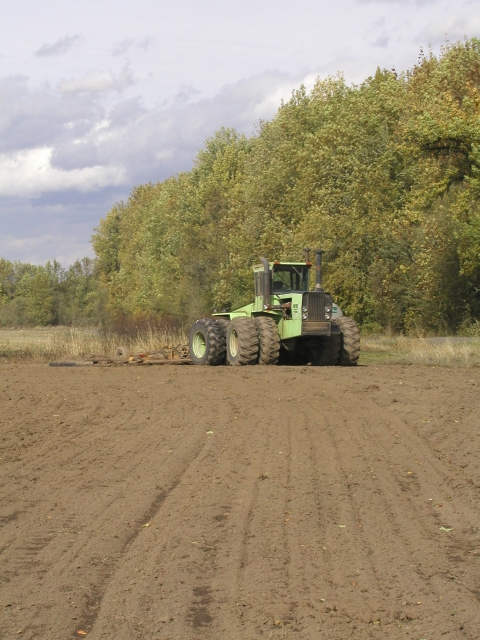 A tractor works the ground at a Willamette Valley Refuge