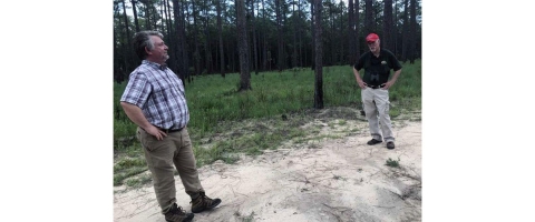 Larry Carlile and Tim Beaty discussing RCW habitat on Ft. Stewart. 