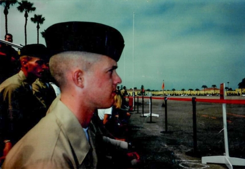 A young man in a military uniform looking off to the right.