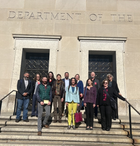 Group photo of Theodore Roosevelt Genius Prize Advisory Council members, Service staff, and prize competition winners taken in front of the Stewart Lee Udall Building in Washington, DC.