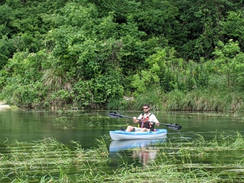 Boater in kayak with Texas wild rice