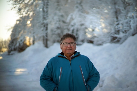 a man in blue standing next to snow