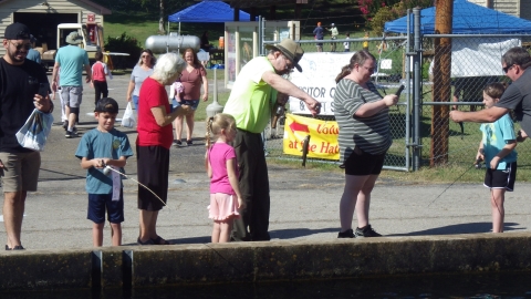 children at the hatchery outdoor adventure fishing in a raceway