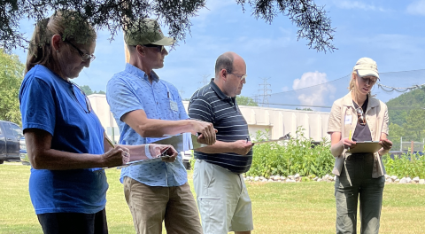 Workshop participants standing in a semi-circle outdoors