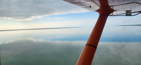 view of an airplane wing over water