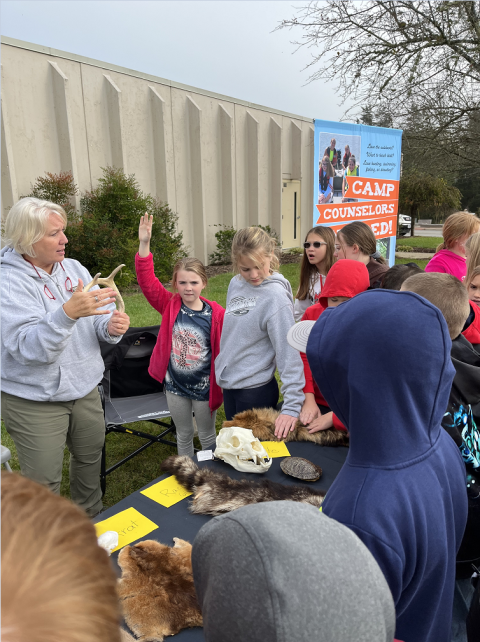 a student raising her hand to ask a question 