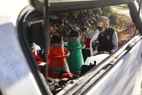 Woman at a microscope set up at at pickup truck