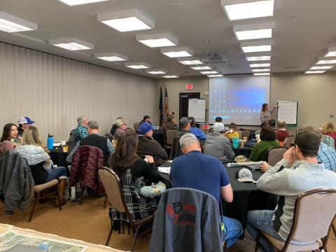 People in a meeting room listening to a presenter