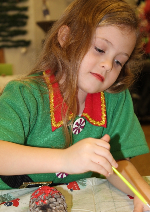Young lady working and focusing hard on her work making an ornament